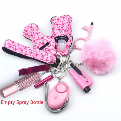 The Kiss Me Later pink self-defense keychain set includes a whistle, alarm, fluffy pom-pom, pepper spray holder, empty spray bottle, and no-touch tool—ideal for outdoor adventures and on-the-go safety.