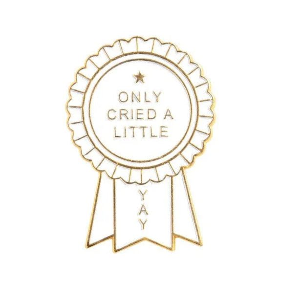 A gold and white enamel pin award ribbon by My Cutesy Era, featuring ONLY CRIED A LITTLE in the center and YAY on a ribbon tail.