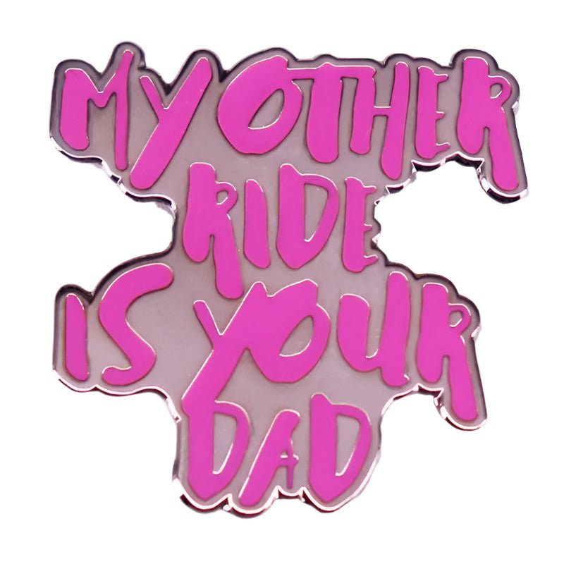 This hot pink enamel pin from My Cutesy Era features bold “MY OTHER RIDE IS YOUR DAD” text in an irregular shape, finished with a shiny metallic outline—a playful statement piece.