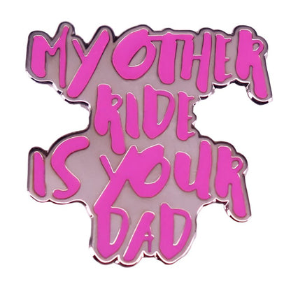 This hot pink enamel pin from My Cutesy Era features bold “MY OTHER RIDE IS YOUR DAD” text in an irregular shape, finished with a shiny metallic outline—a playful statement piece.