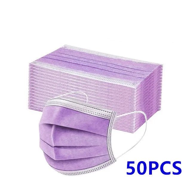 A stack of 50 purple Kiss Me Later disposable medical face masks with ear loops is shown, with one mask in front and 50PCS in blue text on the lower right corner.