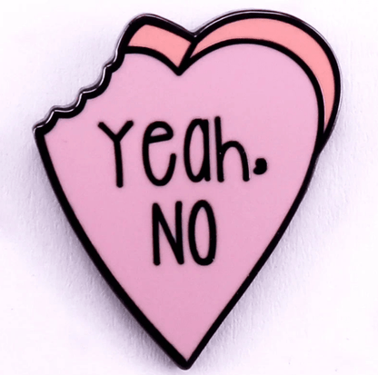 PINK Red enamel pin is shaped like a bitten pink heart with bold black Yeah. NO. text. Both the outline and lettering are strikingly bold and black, giving this playful accessory eye-catching appeal.