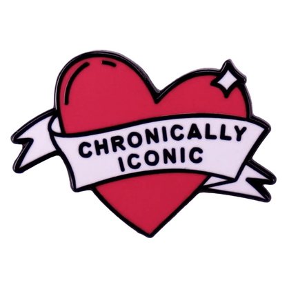 A red heart-shaped enamel pin by with a white CHRONICALLY ICONIC banner, set against a light textured background—an ideal accessory for showing Rainbow Pride in style.
