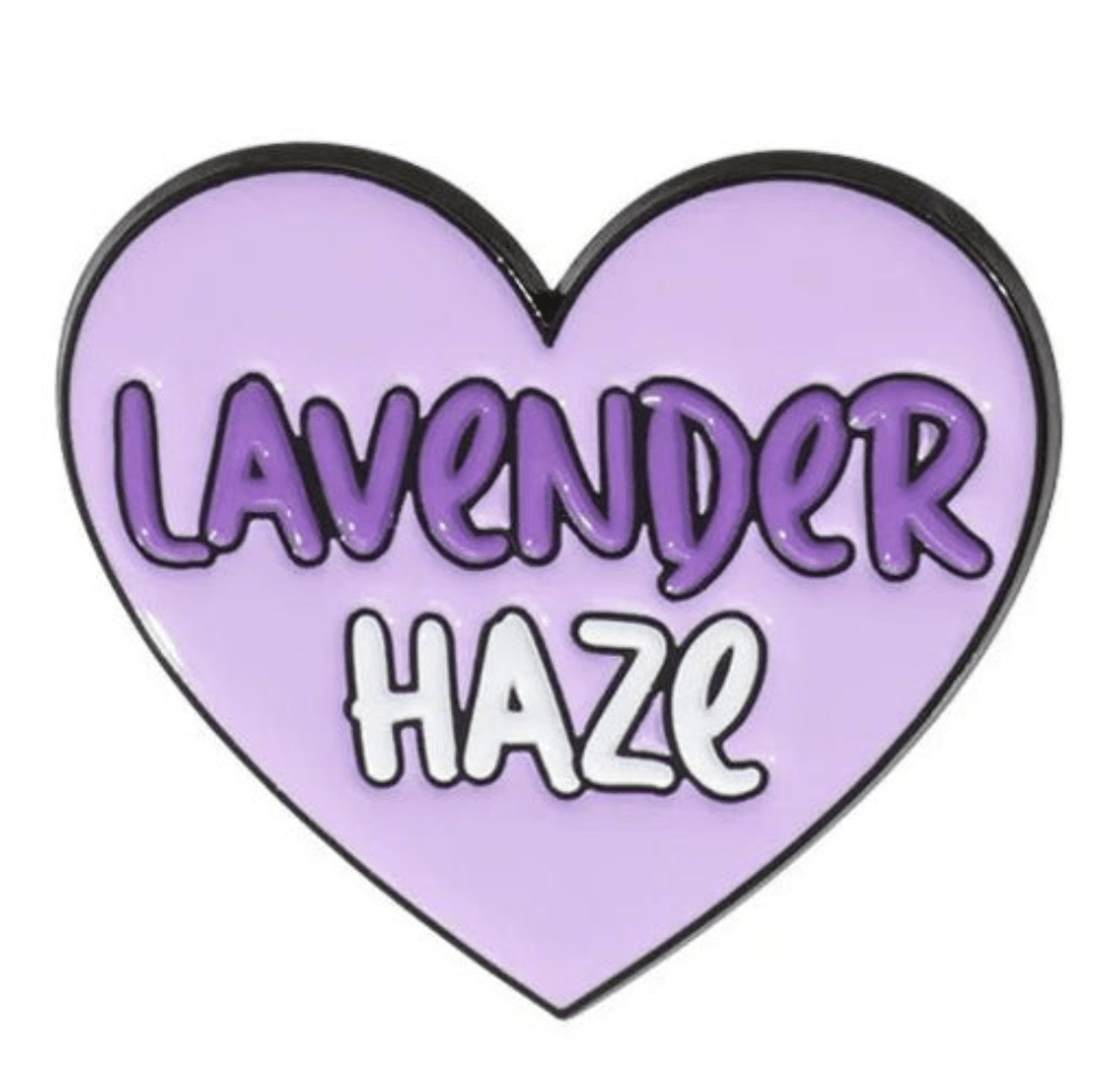 Lavender Haze pin features a light purple, heart-shaped design with LAVENDER in bold dark purple and HAZE in white—a standout enamel pin for your collection.