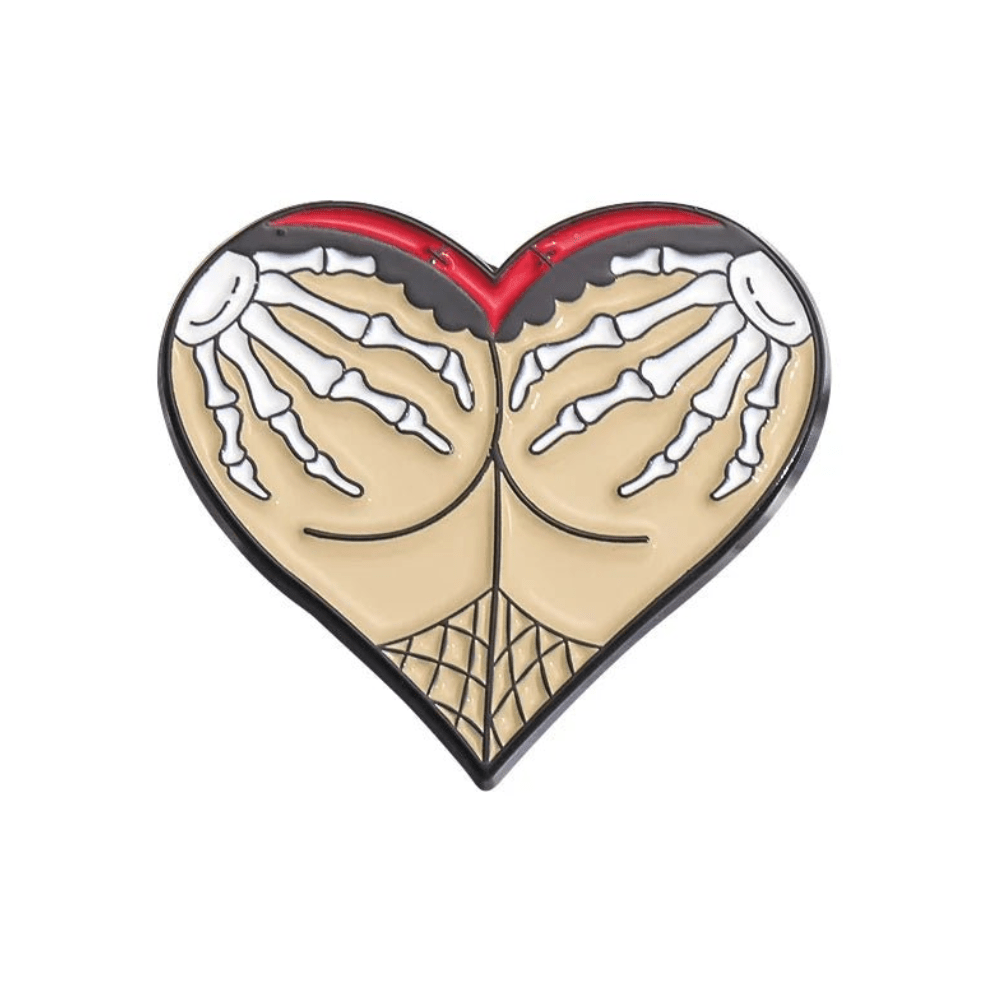 Heart-shaped pin featuring Gothic skeleton hands grabbing buttocks, highlighted by a bold red top border and fishnet pattern below.