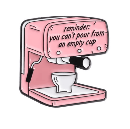 An espresso machine with a cup underneath sits next to a small caution sign. The machine reads: reminder: you can’t pour from an empty cup.