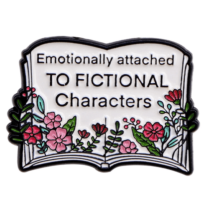 Enamel pin features an open book with colorful flowers and a charming book stack, plus the phrase “Emotionally attached to fictional characters” on its pages.