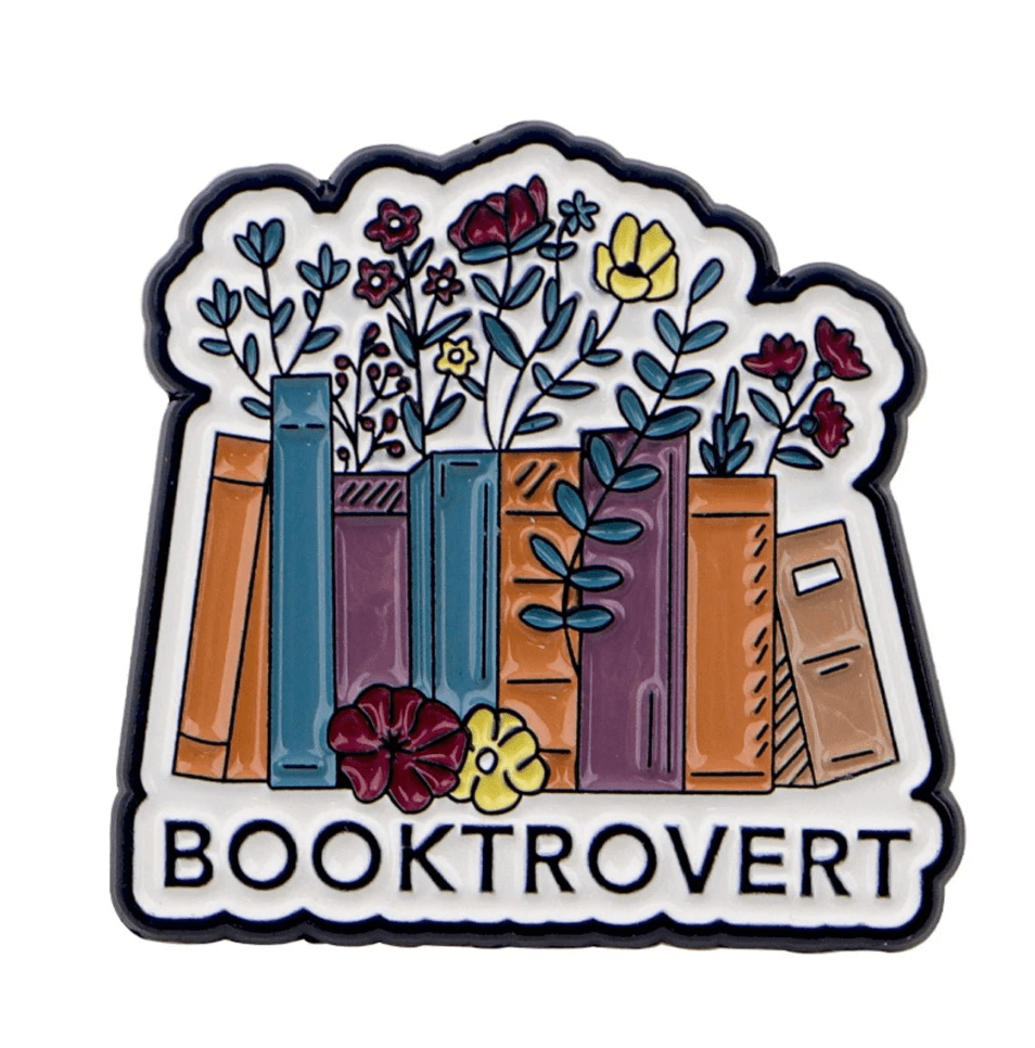 Show off your love for reading with  enamel pin—colorful books with flowers and BOOKTROVERT in bold. It’s a charming accessory to celebrate your bookish side and support public libraries!.