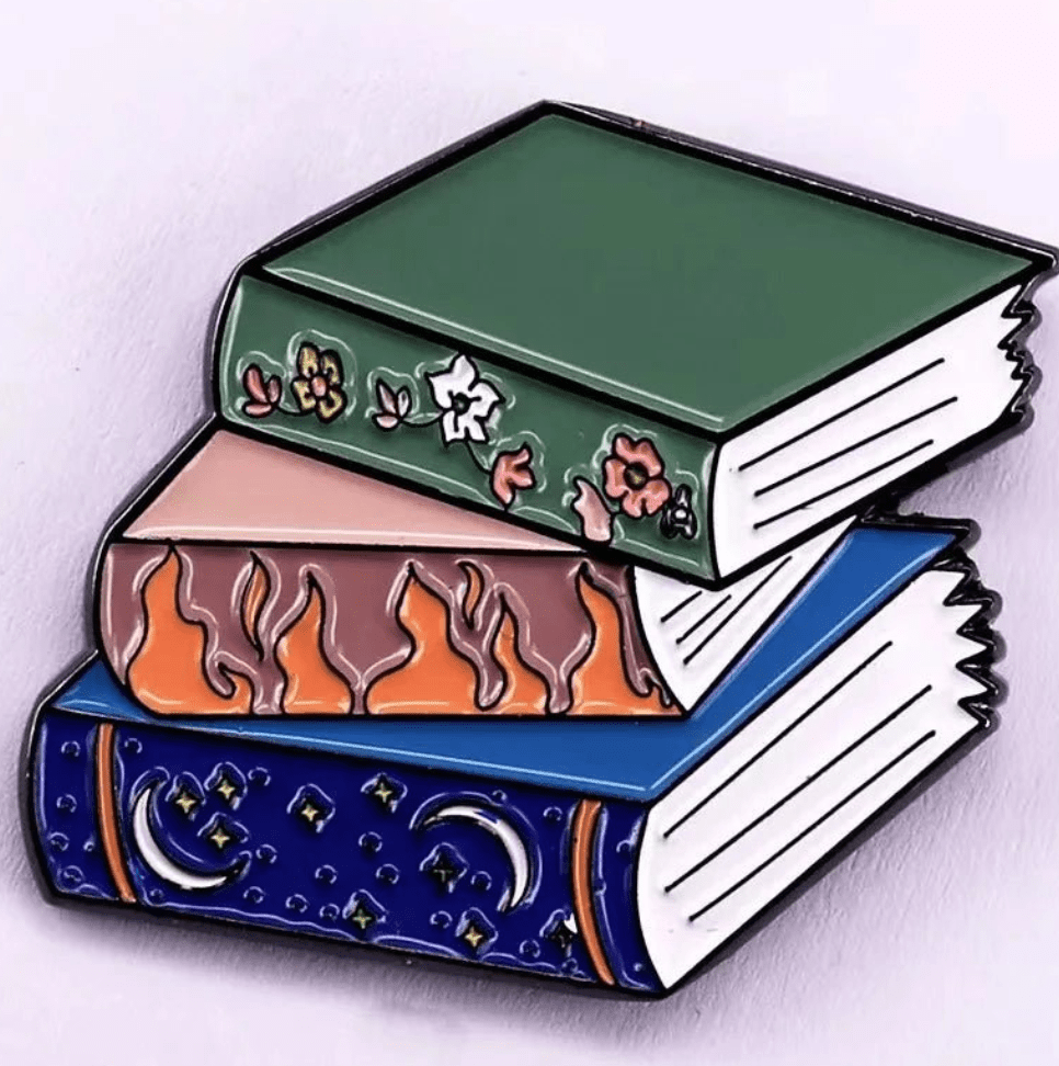 Three illustrated books are stacked: on top, a green floral book for Romance Readers sits above a pink one with flames and a blue one adorned with moons and stars against a light background.