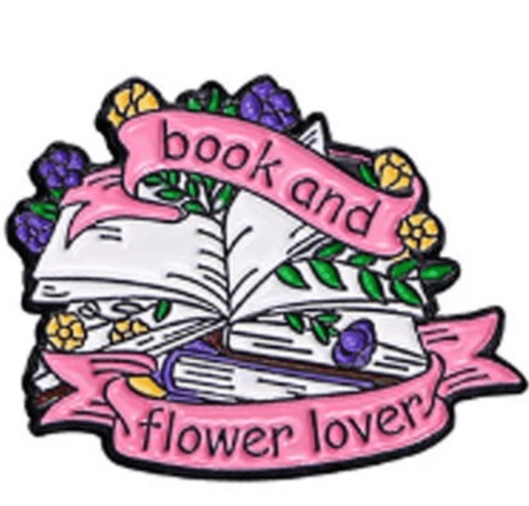 An illustration of open books with colorful flowers and green leaves, plus pink “book and flower lover” banners—perfect as an enamel pin for Romance Reader book lovers and collectors.