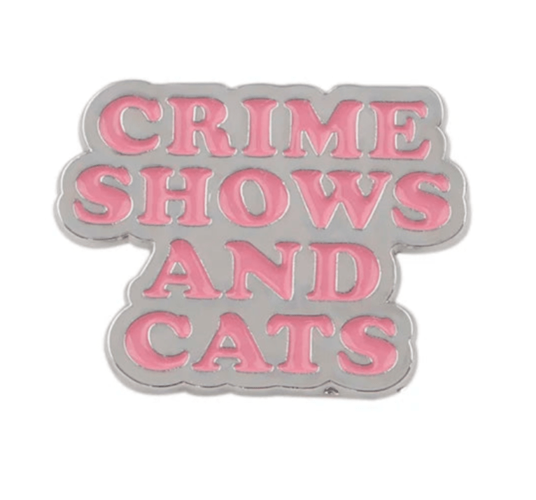 Enamel pin features pink and silver details and pink CRIME SHOWS AND CATS lettering on a white background.