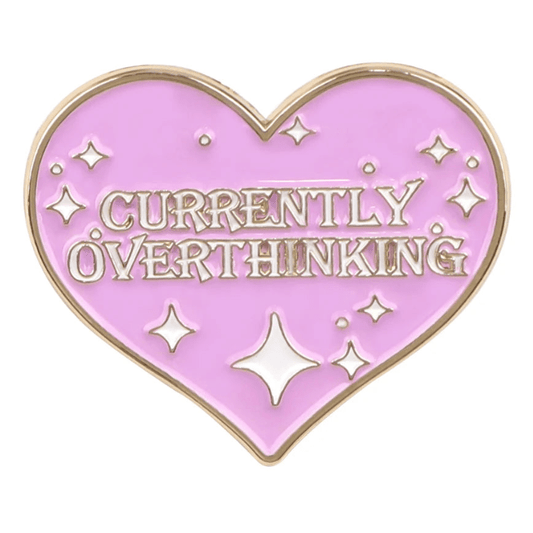 Currently Overthinking pin is heart-shaped with pink enamel, gold edges, sparkles, and gold stylized text—a charming accessory for your collection.