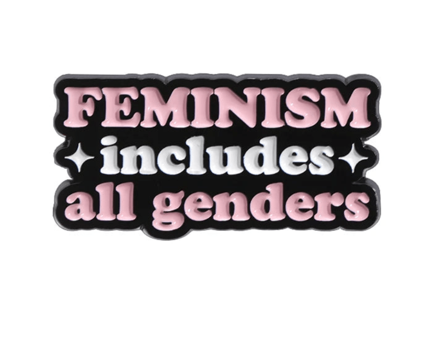 Enamel pin features FEMINISM includes all genders in pink and white on black with two white sparkles—making a bold statement for gender equality beyond the patriarchy.