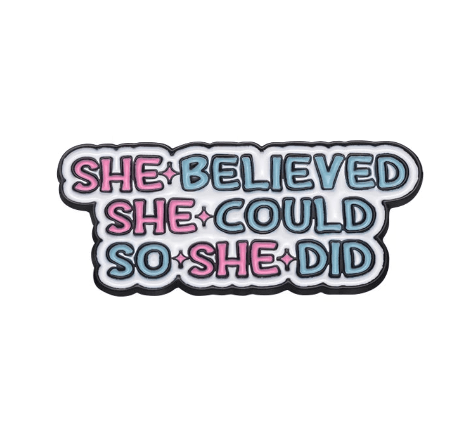 Patch with “She believed she could so she did” in pink and blue bubble letters on white—perfect for your Feminist Pins collection.