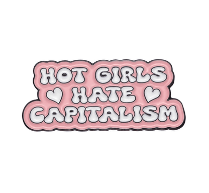 Enamel pin features bold, bubbly pink and white letters reading HOT GIRLS HATE CAPITALISM with two hearts—a perfect feminist accessory for your pin collection.