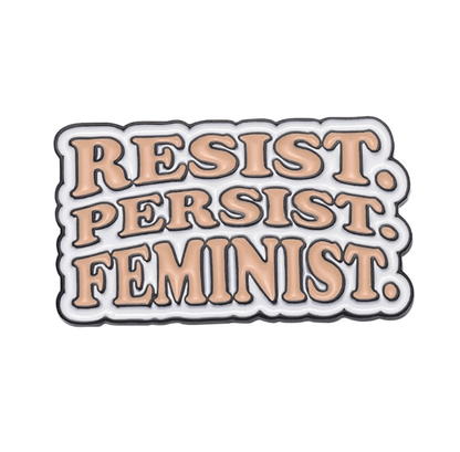 Enamel pin features peach text outlined in black that says RESIST. PERSIST. FEMINIST. on a white background—a bold, must-have accessory for any feminist pin collection.