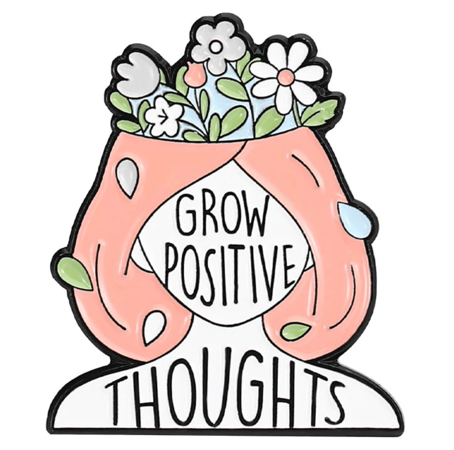 Illustration of a person with pink hair and flowers growing from their head, featuring “Grow Positive Thoughts” pin that inspires and pairs perfectly with feminist or uplifting enamel pins in your collection.