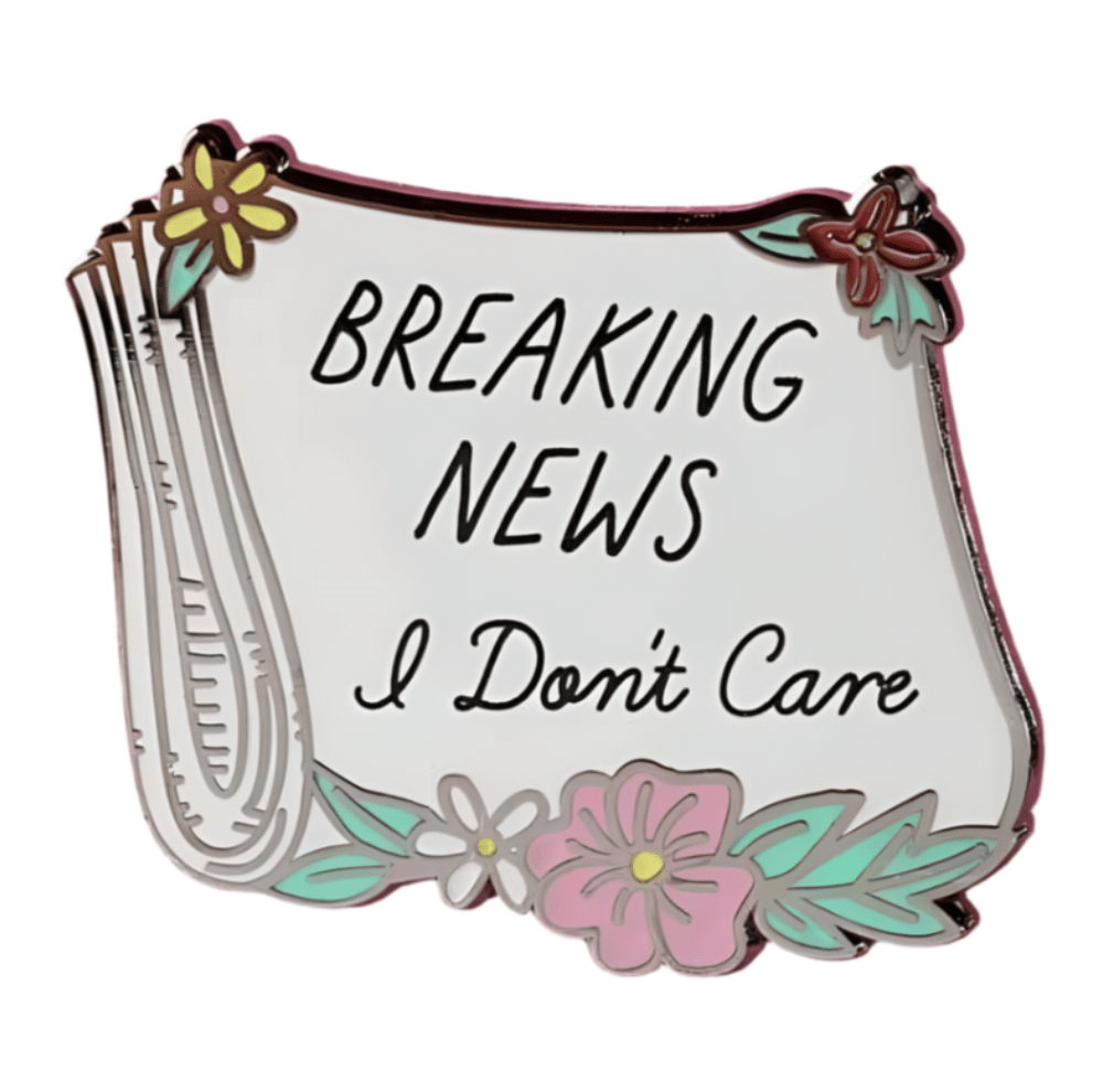 My Cutesy Era enamel pin shaped like a newspaper with flowers, featuring “BREAKING NEWS I Don’t Care” in bold black letters.