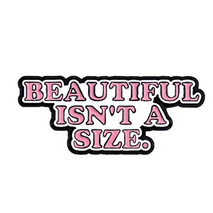 The image shows a 1x1 enamel pin by Kiss Me Later, featuring BEAUTIFUL ISNT A SIZE. in bold pink letters with black and white outlining to promote body positivity and self-acceptance.