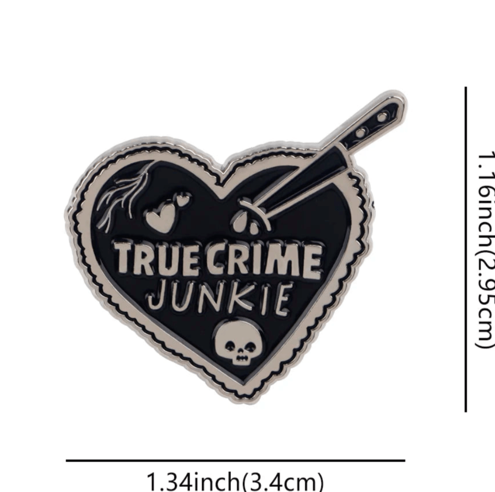 heart-shaped black enamel pin features TRUE CRIME JUNKIE in white, a knife, skull, blood drops, and a broken heart. Perfect for collectors of eerie coffin or skeleton badges. Measures 1.34 × 1.16 (3.4 cm × 2.95 cm).
