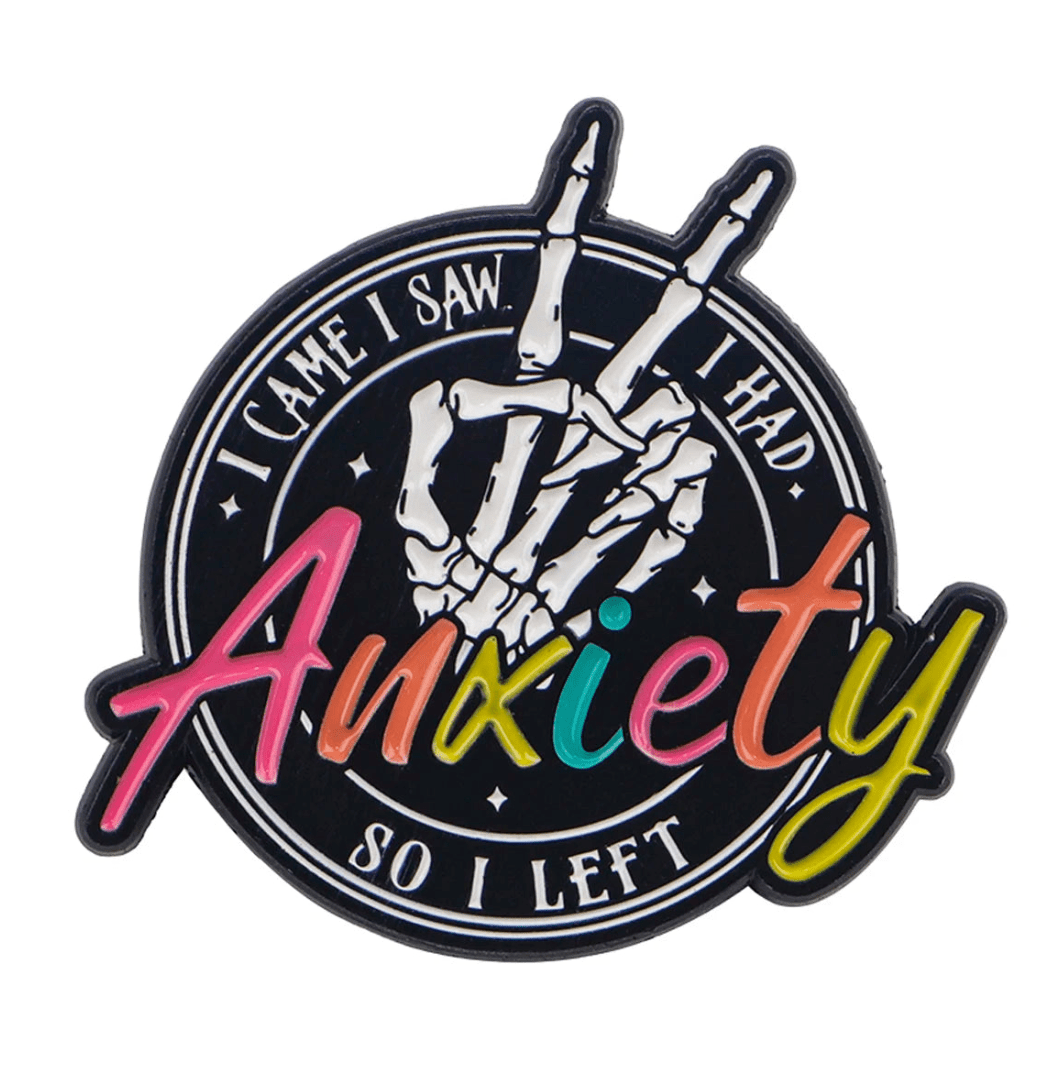 The Kiss Me Later gothic skeleton pin features a skeletal hand making a peace sign and vibrant Anxiety script with the phrase I came I saw I had so I left—a perfect emo edge for your collection.