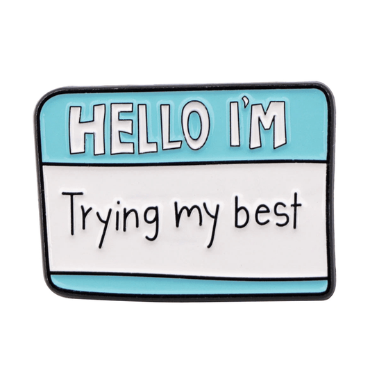 A blue and white name badge-style enamel pin by Kiss Me Later, featuring HELLO IM and Trying my best—the perfect accessory for daily motivation.