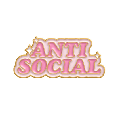 Kiss Me Laters limited edition enamel pin features ANTI SOCIAL in bold pink gradient letters with a gold outline, small gold sparkles, and a white background.