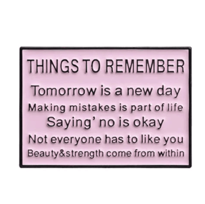A pink Kiss Me Later sign titled Things to Remember features motivational reminders about new beginnings, mistakes, saying no, self-acceptance, and inner beauty—perfect inspiration for a limited edition motivational pin.