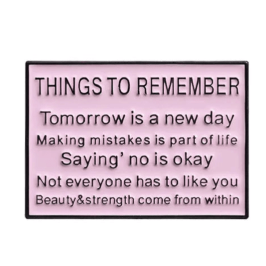 A pink Kiss Me Later sign titled Things to Remember features motivational reminders about new beginnings, mistakes, saying no, self-acceptance, and inner beauty—perfect inspiration for a limited edition motivational pin.