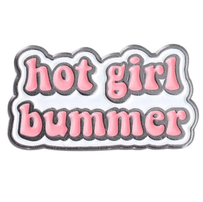 Show off your attitude with the Hot Girl Bummer pin—bold pink bubble letters on a crisp white background, outlined in black. A stylish accessory for any jacket or bag!.
