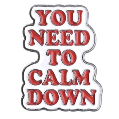 A white enamel pin with bold red YOU NEED TO CALM DOWN lettering on four lines, silver outline, and white background—ideal for fans of the Hot Girl Bummer pin.