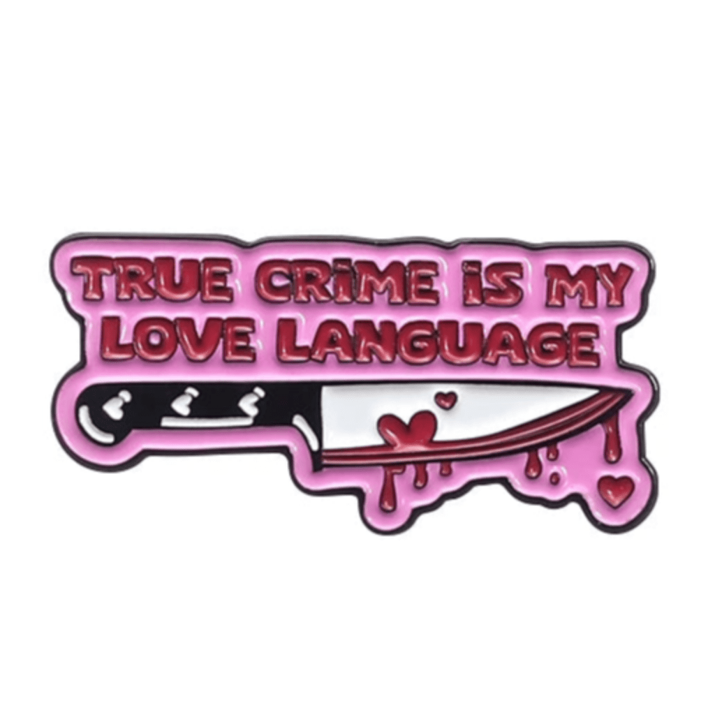 A playful yet dark enamel pin by My Cutesy Era featuring pink TRUE CRIME IS MY LOVE LANGUAGE text above a bloody knife with dripping blood and hearts—perfect for any Dark Romance Book Club fan.