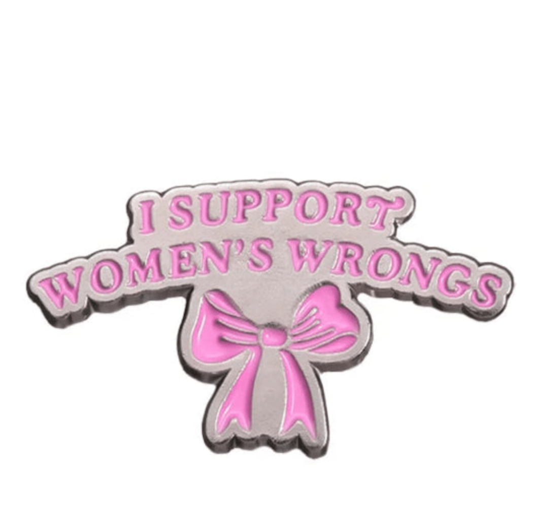 My Cutesy Era’s feminist enamel pin features pink “I SUPPORT WOMEN’S WRONGS” text above a pink bow on a silver background—ideal for empowered women who support gender equality.