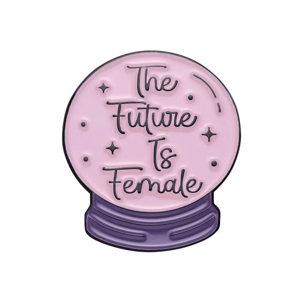 A pink crystal ball by My Cutesy Era with The Future Is Female in cursive, resting on a purple star-accented base—perfect for displaying beside your motivational or body positive enamel pin collection.
