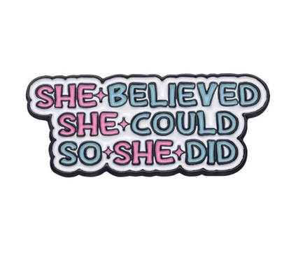 My Cutesy Era badge with the quote She believed she could so she did in bold pink and blue letters, outlined in black on a light blue and white background.