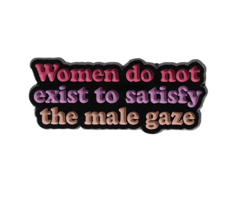 Show your spirit with My Cutesy Eras bold pin: “Women do not exist to satisfy the male gaze” in colorful text on black—perfect for anyone who knows well-behaved women rarely make history.
