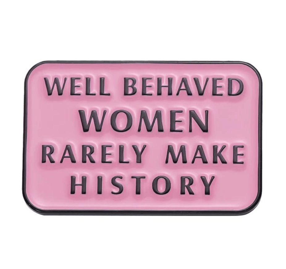 My Cutesy Era’s pink rectangular enamel pin features bold black text: “Well behaved women rarely make history”—a motivational accessory designed to inspire confidence and spark conversation.