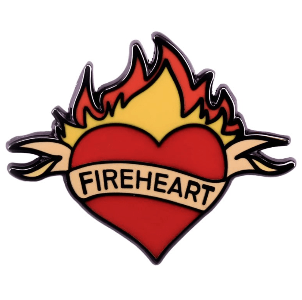 My Cutesy Era’s enamel pin features a red heart surrounded by yellow and orange flames, with a tan banner that reads FIREHEART.