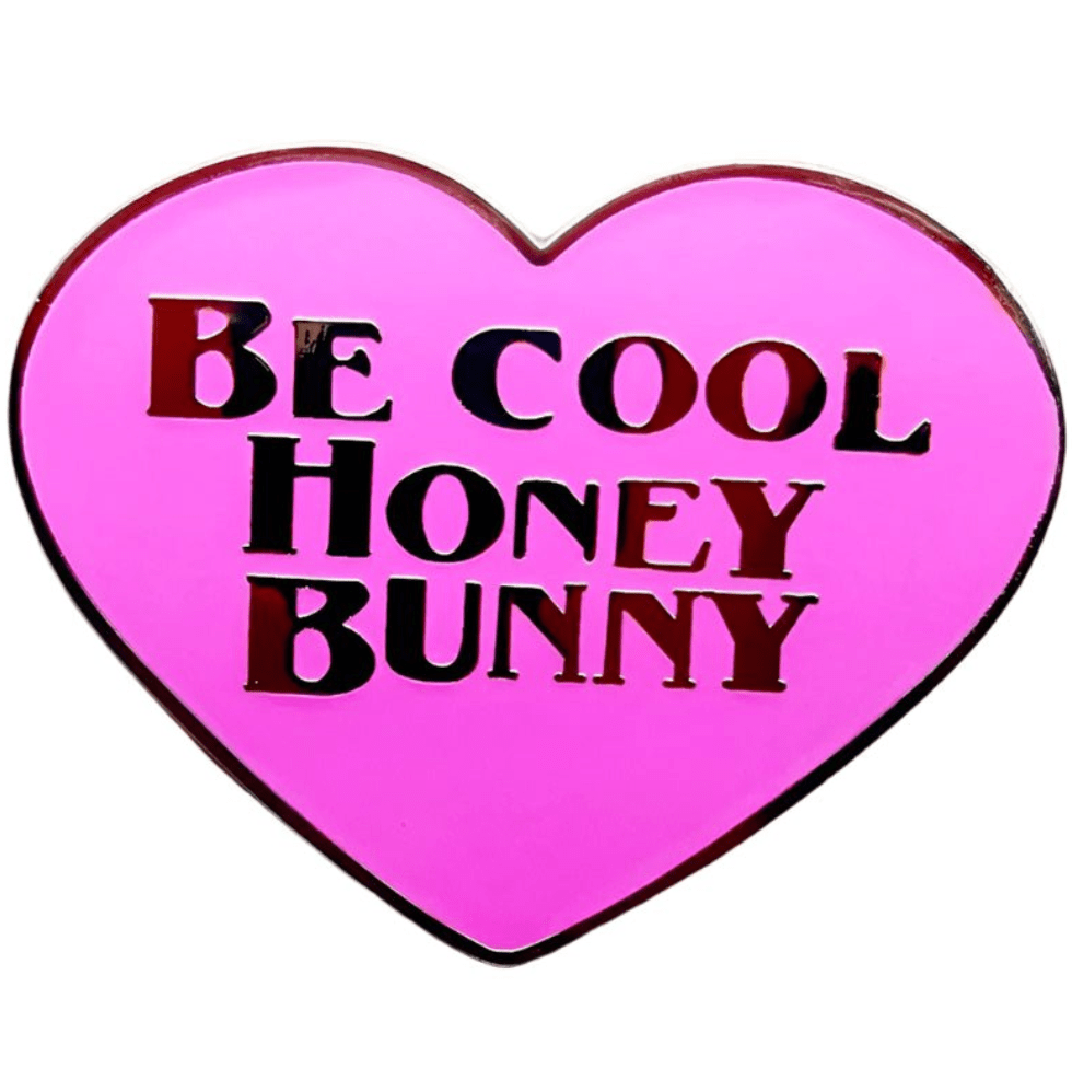 This pink heart-shaped pin from My Cutesy Era features Be Cool Honey Bunny in bold black and red letters.