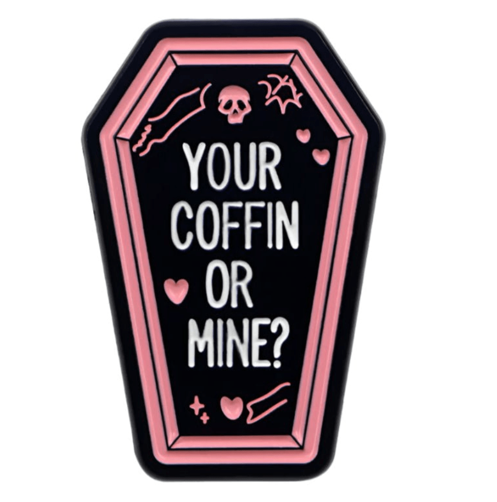 My Cutesy Eras coffin-shaped true crime pin features a pink outline, white Your coffin or mine? text on black, and cute details like pink hearts, bones, a skull, and a bat for extra charm.