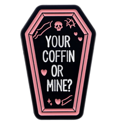 My Cutesy Eras coffin-shaped true crime pin features a pink outline, white Your coffin or mine? text on black, and cute details like pink hearts, bones, a skull, and a bat for extra charm.