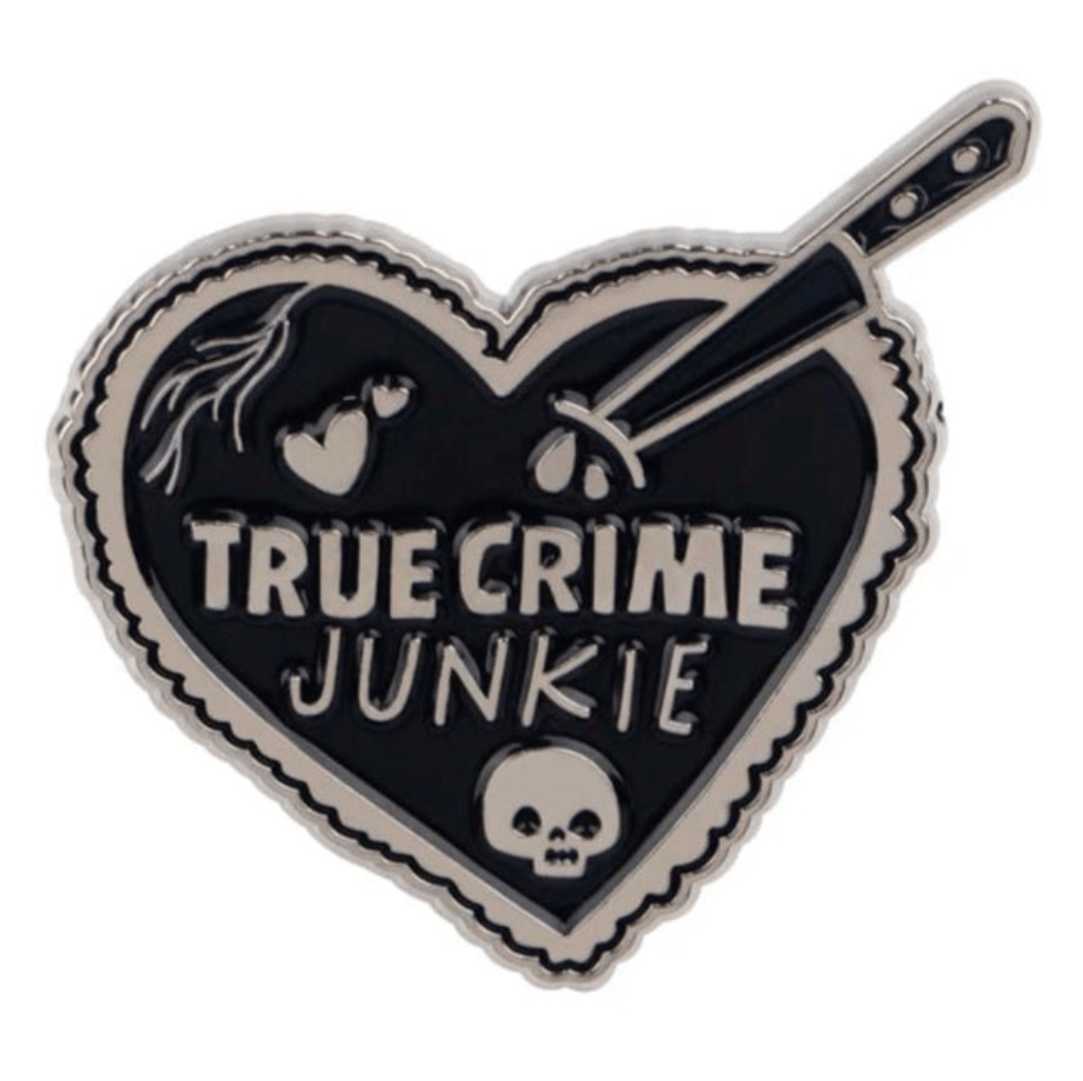 My Cutesy Era heart-shaped black pin with scalloped edges features TRUE CRIME JUNKIE, a skull, knife and drops, and a broken heart graphic—perfect for true crime fans.