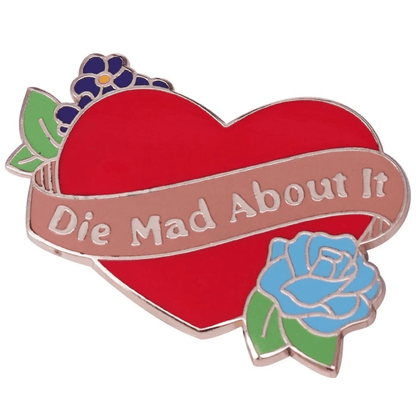My Cutesy Era’s vibrant floral enamel pin features a red heart with purple and blue flowers and a pink banner that says Die Mad About It in white letters.