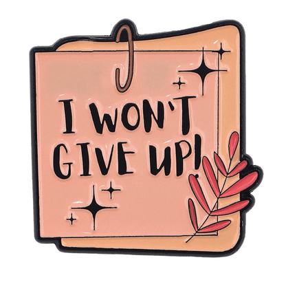 From My Cutesy Era, this pink enamel pin is shaped like a notepad with “I WONT GIVE UP!” in bold black letters, sparkles, and a pink leafy branch—perfect as a motivational mental health reminder or positive affirmation.