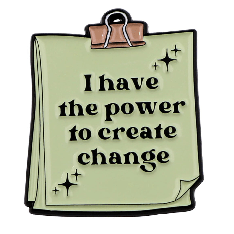 A stack of light green papers clipped together with a binder clip, featuring “I have the power to create change” and small sparkles—a motivational affirmation for mental health from My Cutesy Era.