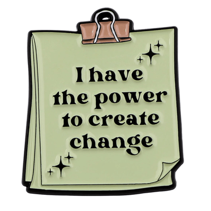 A stack of light green papers clipped together with a binder clip, featuring “I have the power to create change” and small sparkles—a motivational affirmation for mental health from My Cutesy Era.