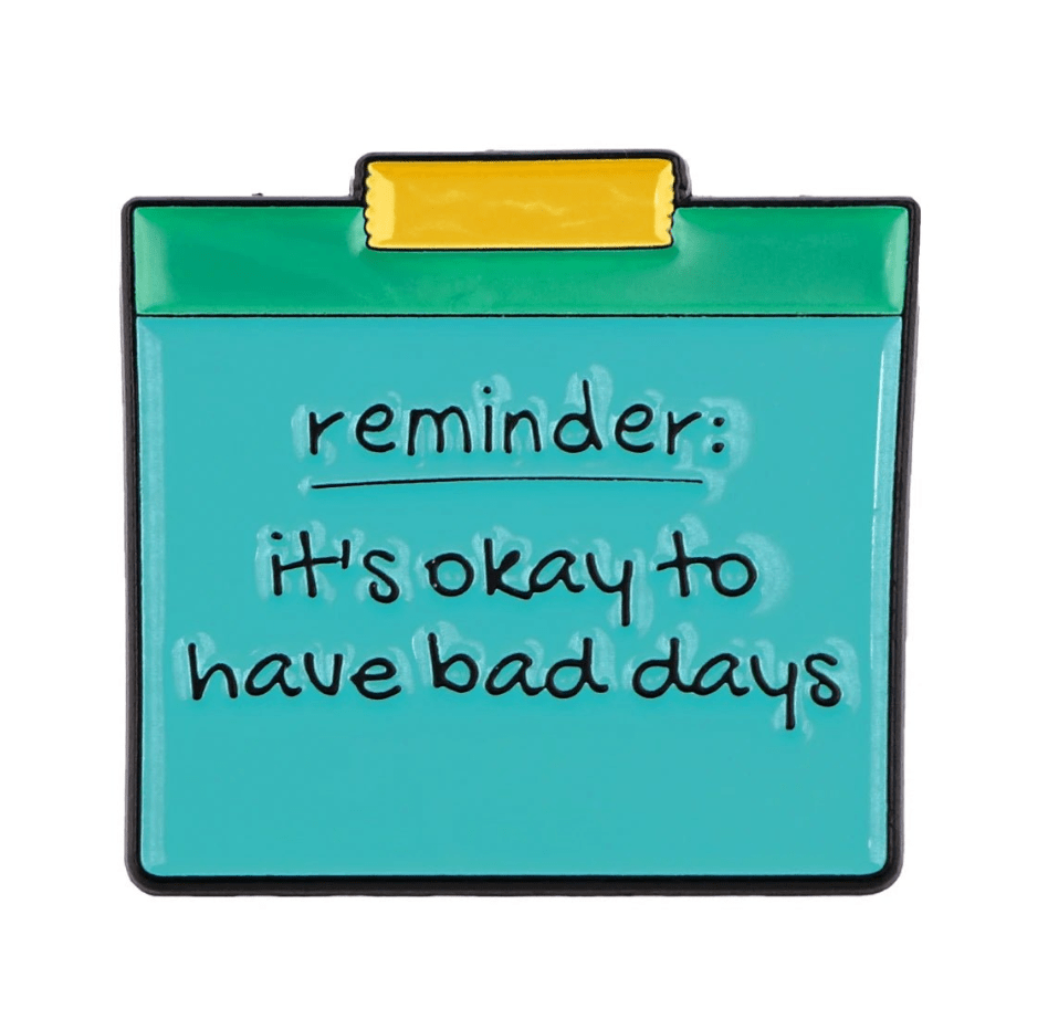A My Cutesy Era teal note, pinned with yellow tape, features a handwritten black motivational message—reminder: its okay to have bad days—on a white background.