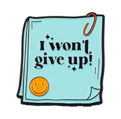 My Cutesy Eras blue notepad features a red paperclip, yellow smiley face, and bold black I wont give up! text on the cover—a perfect motivational reminder for positive affirmations and mental health support.