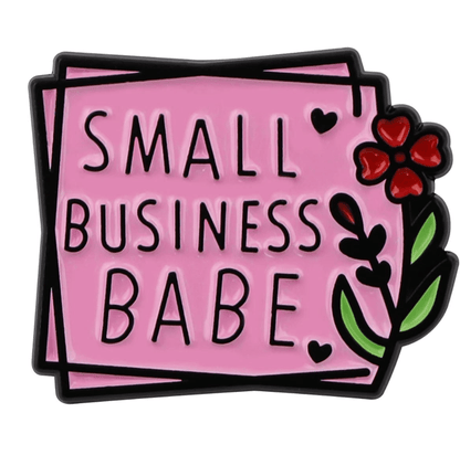 The My Cutesy Era pink enamel pin reads Small Business Babe in bold black letters, adorned with small hearts, a red flower, and green leaves—a motivational reminder and positive affirmation for entrepreneurs.