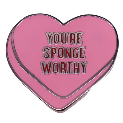 The My Cutesy Era pink heart enamel pin features YOURE SPONGE WORTHY in bold silver and red letters on the front.